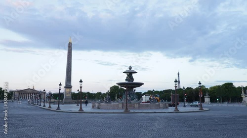 Plave de la concorde with fountain and luxor obelisk with fery few trafic and cars during early morning in Paris, arc wide shot photo