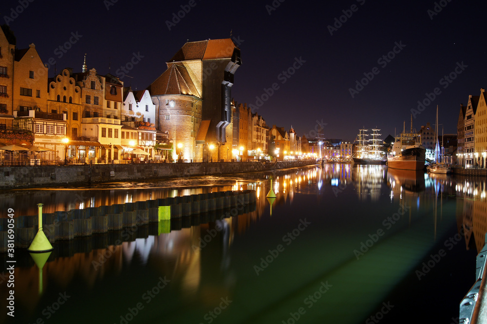 Night panorama of Old Town's waterfront in Gdansk. Yachts moored at Motlawa river.