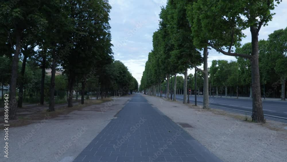 Empty sidewalk in the gardens of the champs élysées in Paris during covid outbreak with nobody, wide dolly in shot Empty sidewalk in the gardens of the champs élysées in Paris during covid outbreak with nobody, wide dolly in shot
