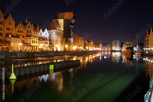 Night panorama of Old Town's waterfront in Gdansk. Yachts moored at Motlawa river.