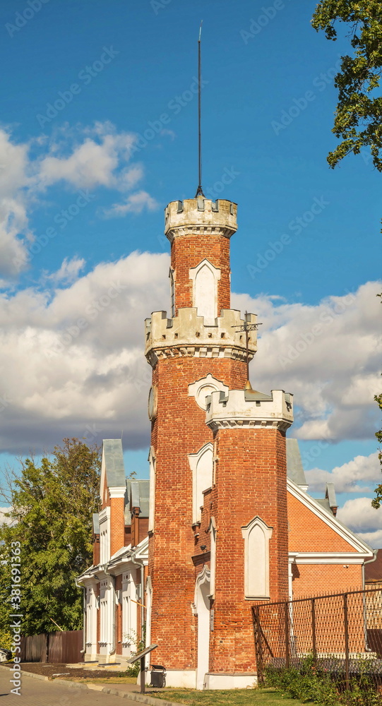 Old pseudo-gothic red brick castle tower