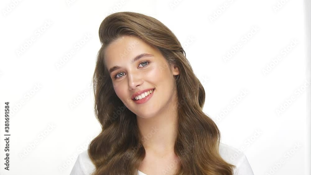 charming girl with perfect wavy hair smiling to camera and moving with head charming girl with perfect wavy hair smiling to camera and moving with head