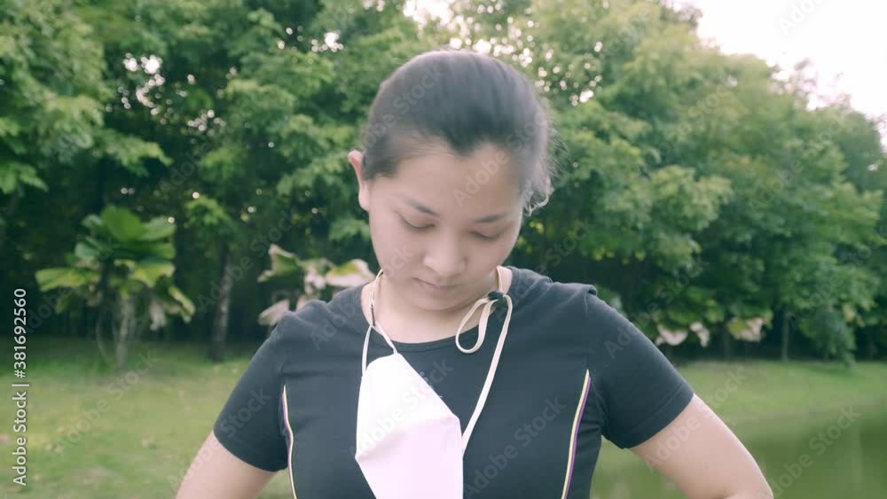 Asian woman exercise in park outdoor with new normal in COVID-19 situation Asian woman exercise in park outdoor with new normal in COVID-19 situation