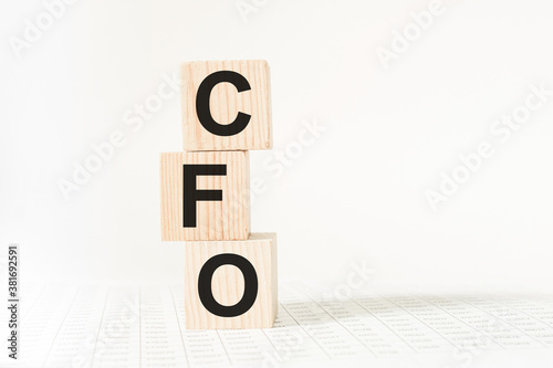 words CFO on wooden cubes, white background. business concept