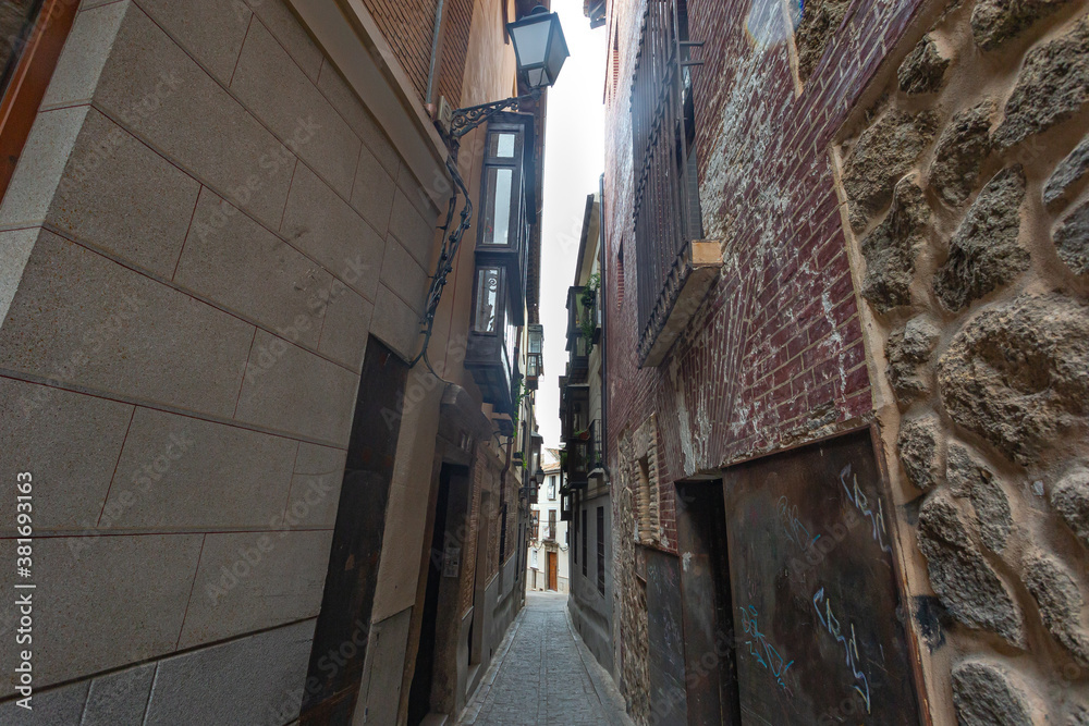 Narrow and old streets with stone and mud buildings in the city of Toledo