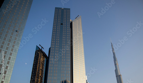 Towers in Dubai International Financial Center, Burj Khalifa, Tallest building in the world can be seen in the scene.