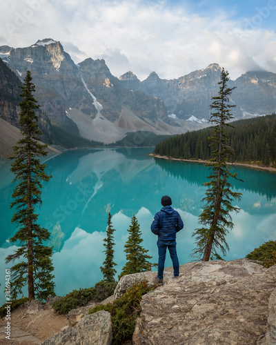 A man standing over the Rockpile Trail looking over Moraine Lake (Banff, Alberta, Canada)