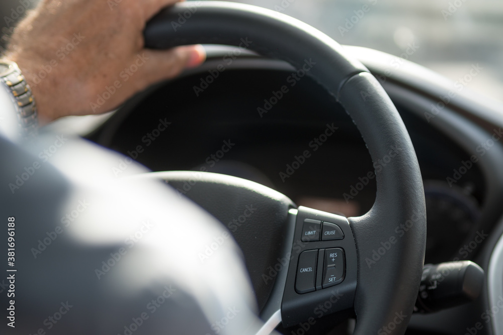Car driver hand on the steering wheel of a car