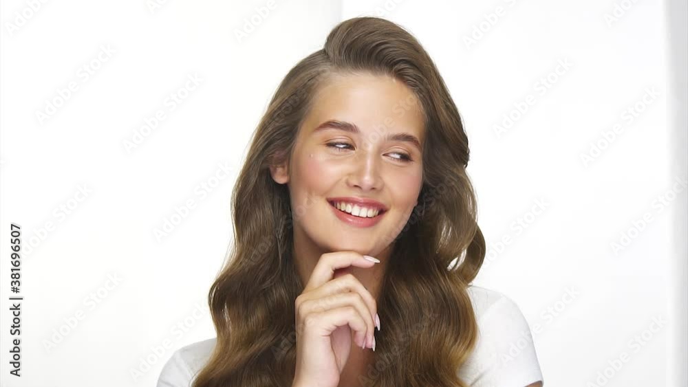 cute girl with healthy long curls smiling with flirtatious look cute girl with healthy long curls smiling with flirtatious look