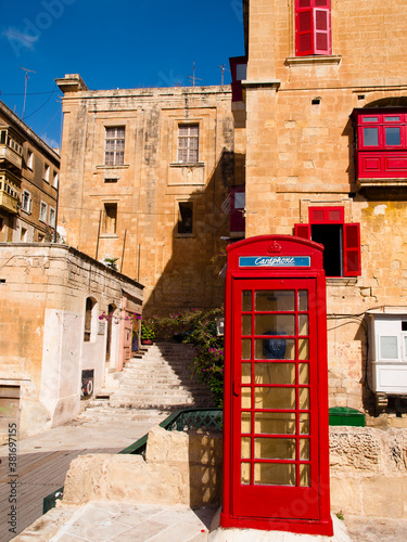 Red balconies and red telephone booth in Valletta, Malta
