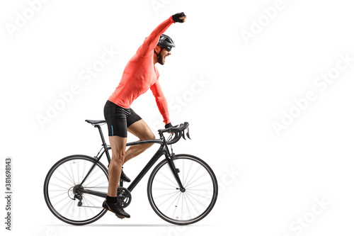 Fototapeta Naklejka Na Ścianę i Meble -  Male cyclist riding a road bicycle and gesturing win with hand