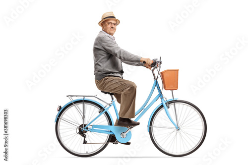 Elderly man riding a blue bicycle and smiling