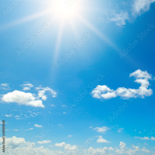 blue sky with white clouds and sun.