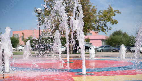 fountain splashes outdoor in the town public park during summer season day holidays