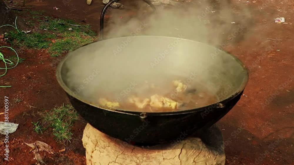 Above view of smoke and heat from cooked cow meat in wok outside Above view of smoke and heat from cooked cow meat in wok outside