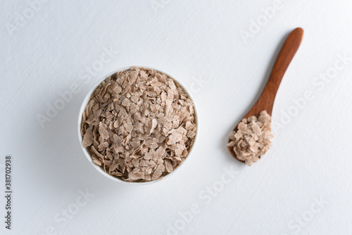 Flattened rice or Aval used to make Kerala breakfast Aval Upma or Pohe on white background Tamilnadu South India. Top view of Indian food ingredients. photo