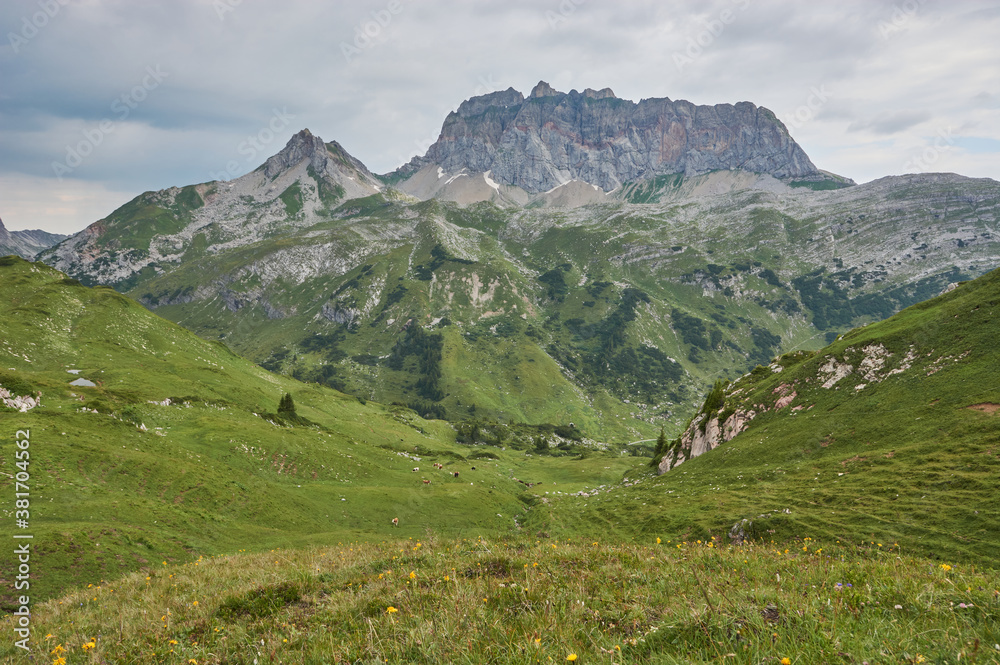 Beautiful lonely mountain landscape. Rocky mountain peak in the clouds. Mountain panorama in the alps. Beautiful lonely mountain landscape. Rocky mountain peak in the clouds. Mountain panorama in the alps.
