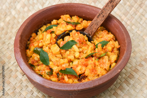 Popular traditional South Indian food cooked young jackfruit / jakfruit / jack / jak with turmeric, chilly, grated coconut in earthen ware Kerala, India. served with fish curry. Indian food, spices