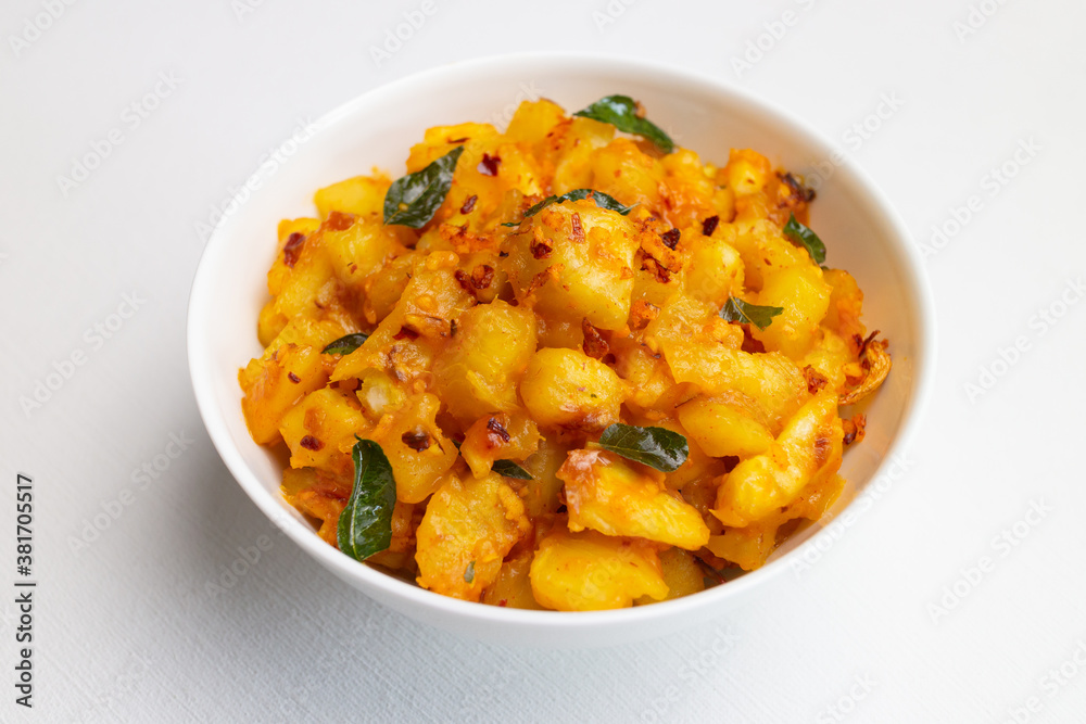 Popular traditional South Indian food cooked tapioca / cassava root / mandioca / aipim with grated coconut in earthen ware Kerala, India. root vegetable Brazil. served with Fish curry, chutney Popular traditional South Indian food cooked tapioca / cassava root / mandioca / aipim with grated coconut in earthen ware Kerala, India. root vegetable Brazil. served with Fish curry, chutney