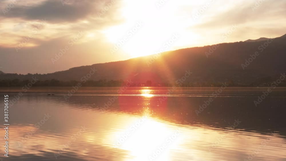 Timelapse of the Sun Setting on a Lake with Fiery Clouds Timelapse of the Sun Setting on a Lake with Fiery Clouds