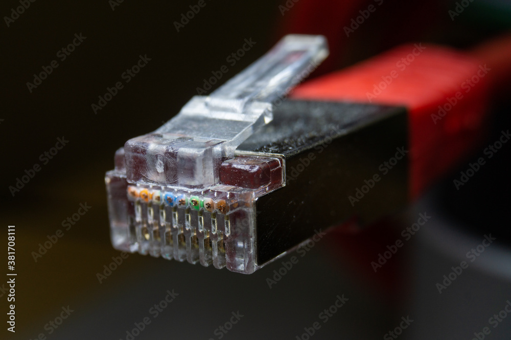 Macro cross section front angle view of red RJ45 CAT6 shielded network data internet cable clear connector Macro cross section front angle view of red RJ45 CAT6 shielded network data internet cable clear connector
