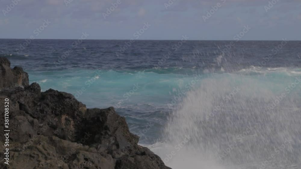 A big wave crashing into rocks in the Indian Ocean, île de la Réunion, France A big wave crashing into rocks in the Indian Ocean, île de la Réunion, France