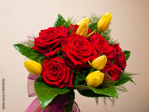 A bouquet of red roses and yellow tulips photo