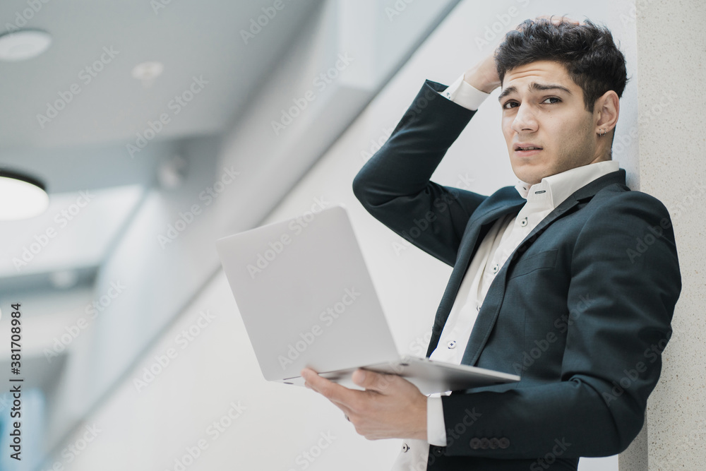 portrait of a young man of caucasian appearance looking at the camera. worried business man in a formal suit. Corresponding with a client about a meeting and discussion of a new strategy. portrait of a young man of caucasian appearance looking at the camera. worried business man in a formal suit. Corresponding with a client about a meeting and discussion of a new strategy.