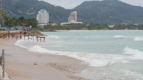 Waves are splashing to the beach shore in a calmly manner, visually pleasing capturing on Patong Beach Phuket, Thailand. photo