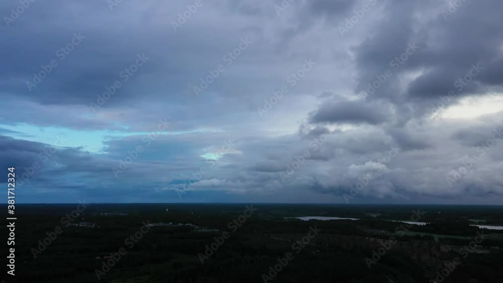 Aerial view of a dark, rain clouds moving over moody sky and forest, bad weather, on a summer evening, in Sweden, Scandinavia, North Europe - tracking, drone shot Aerial view of a dark, rain clouds moving over moody sky and forest, bad weather, on a summer evening, in Sweden, Scandinavia, North Europe - tracking, drone shot