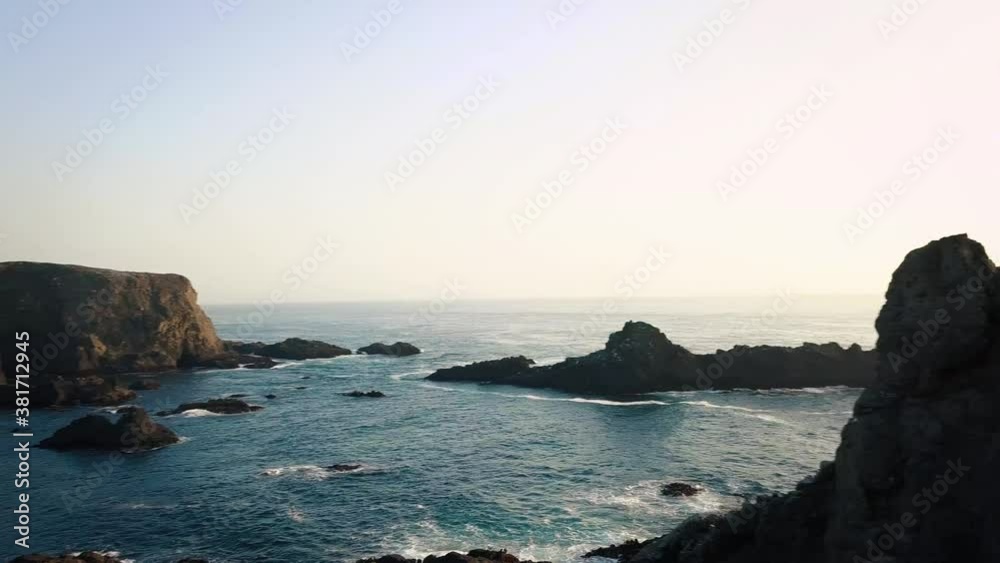 Aerial view of ocean waves crashing the California rocky coast. Aerial view of ocean waves crashing the California rocky coast.