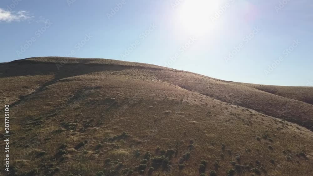 flying up a desert hill into the sun. flying up a desert hill into the sun.