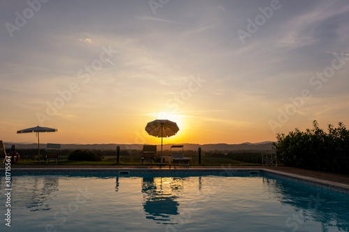 Outdoors sunset swimmingpool. Tropical resort hotel