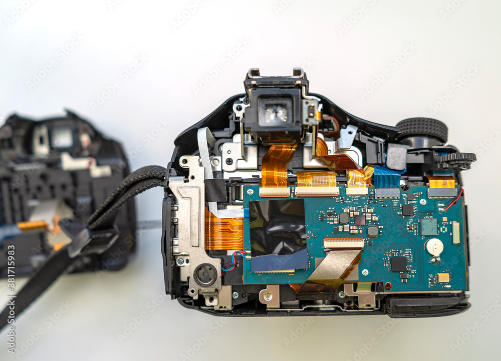Fototapeta premium Parsing a digital camera. Digital camera in partially disassembled form, visible chips and loops.