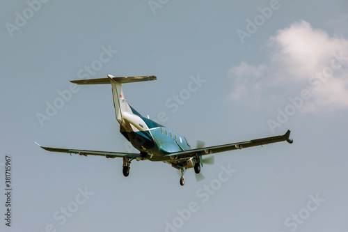 Single-engine blue airplane flying on a sunny day in the blue sky. The plane rises after takeoff. photo