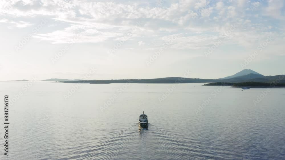 Boat Sailing Across The Northern Adriatic Sea In The Town Of Mali Losinj, Island Of Losinj In Croatia - drone pullback shot Boat Sailing Across The Northern Adriatic Sea In The Town Of Mali Losinj, Island Of Losinj In Croatia - drone pullback shot