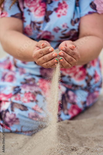 girl pouring sand from her hands