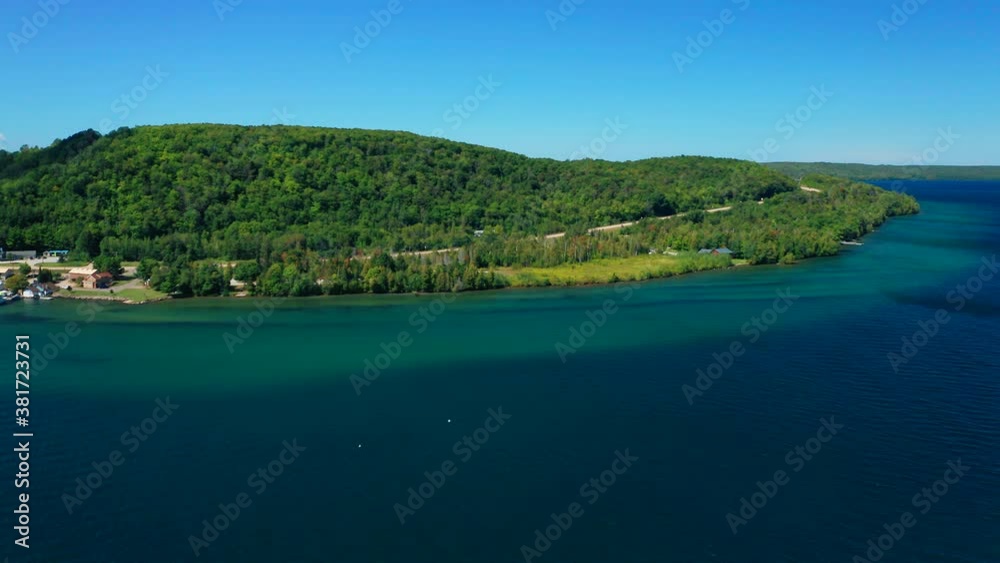Drone Aerial Horizon of Small Village Shoreline with Cottage Getaway and Trees on a Summery Lake Drone Aerial Horizon of Small Village Shoreline with Cottage Getaway and Trees on a Summery Lake