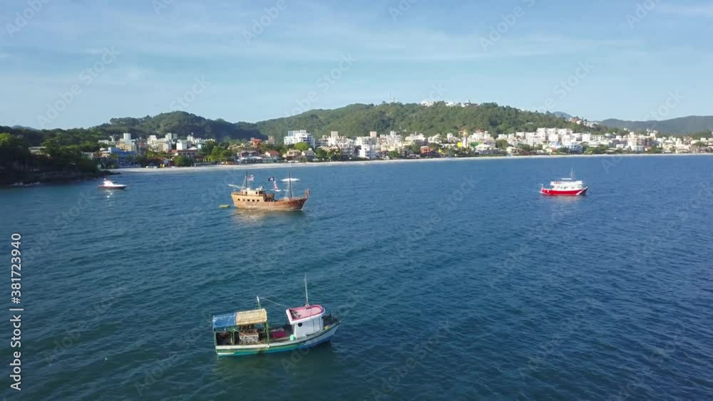 Aerial dolly out shot of fishing boats working on the sea near Bombinhas beach, Brazil Aerial dolly out shot of fishing boats working on the sea near Bombinhas beach, Brazil