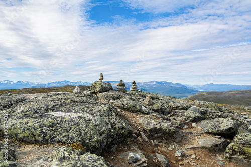 Stone towers on the rocks and mountain view on the background, Saana, Enontekio, Kilpisjarvi, Lapland, Finland © hivaka