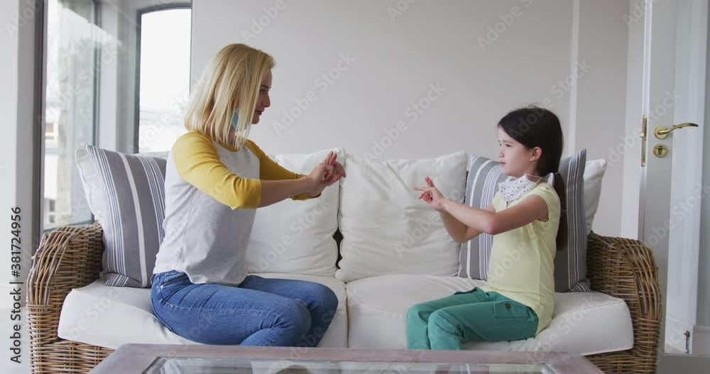 Mother and daughter talking to each other through sign language