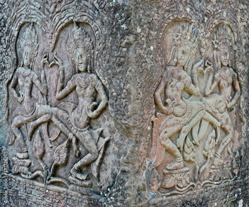 Ancient bas-reliefs depicting people in Angkor