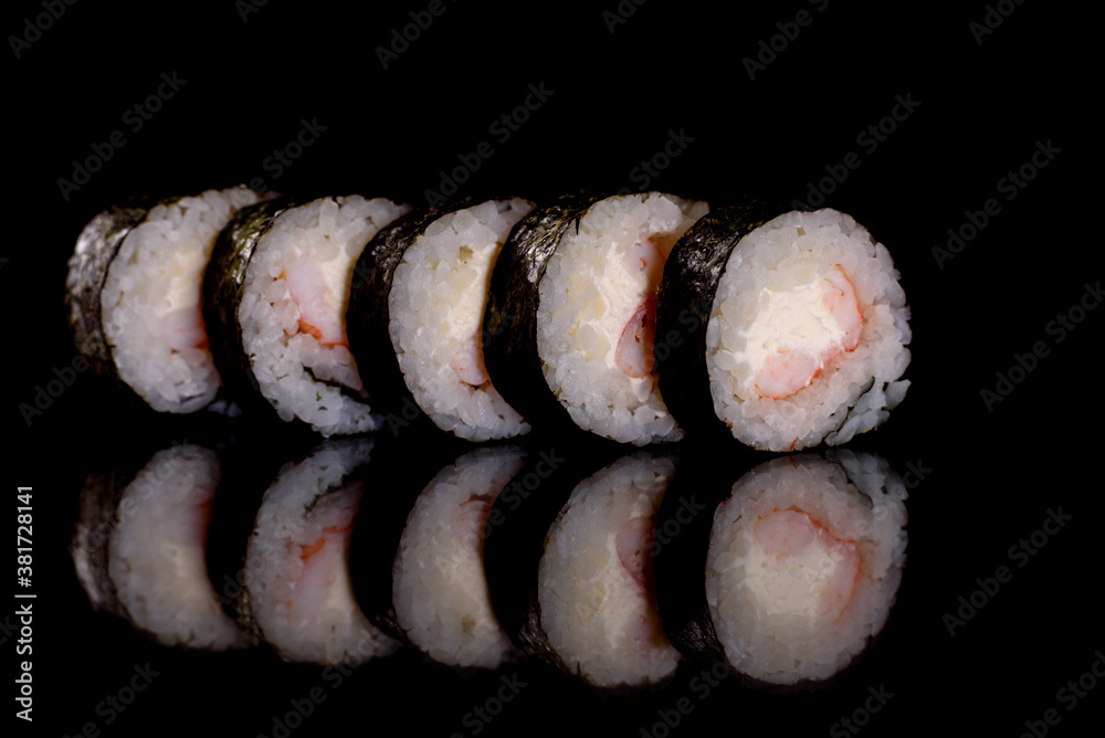 Fresh delicious beautiful sushi rolls on a dark background