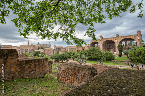 Scenic view of ancient roman ruins in the Forum Romanum. Tourists visit the Roman Forum ancient ruins in the historic center of Rome, Italy