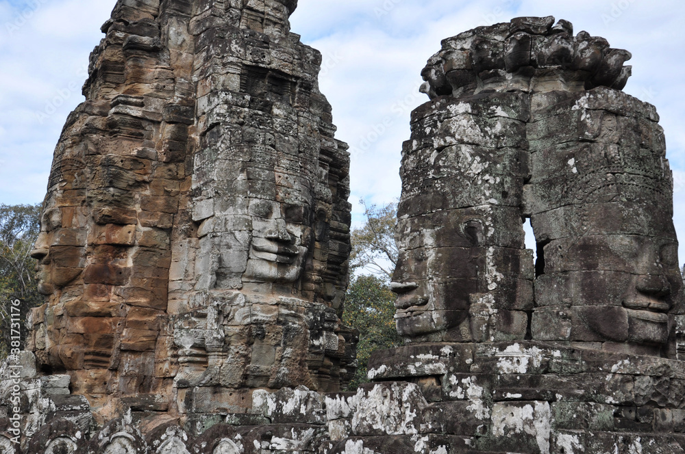 Giant stone faces at Bayon Temple in Angkor Wat, the massive Khmer religious complex in Siem Reap, Cambodia