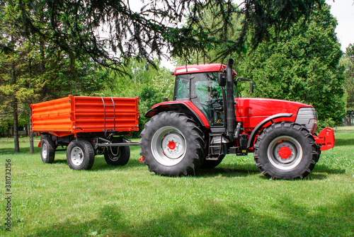 Farmer driving agricultural tractor and trailer