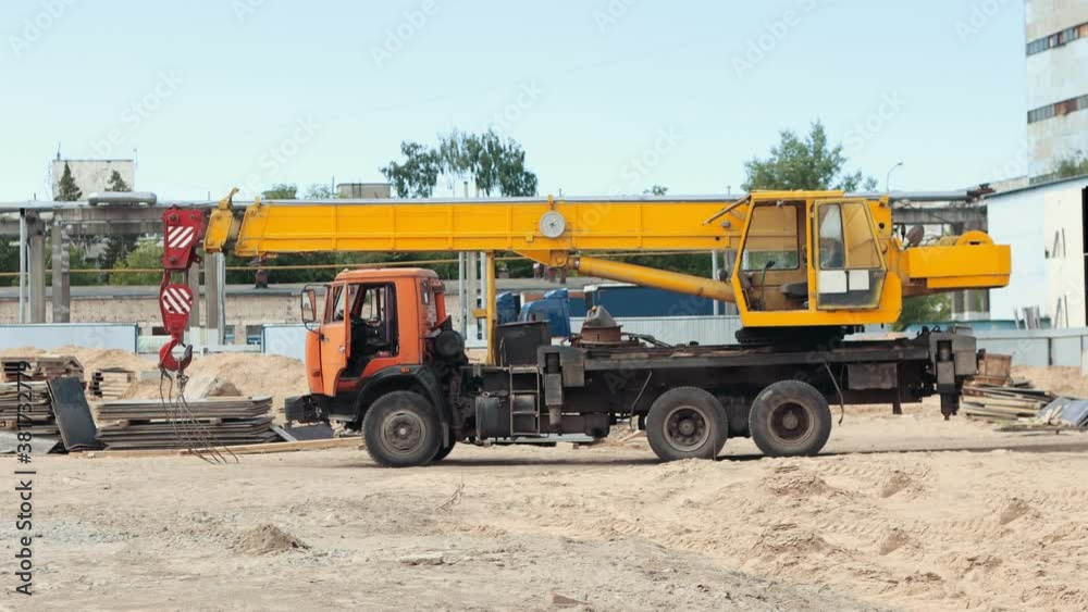 A machine with lifting crane parked on the construction site A machine with lifting crane parked on the construction site