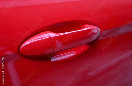 Closeup a red car's door outside handle 