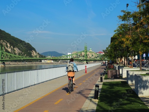 Photography Budapest, Hungary - September 15, 2020: Cyclist woman with backpack on bike path