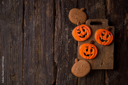 halloween gingerbread cookies in the form of pumpkins on a wooden table with copy space. background. All Saints' Day